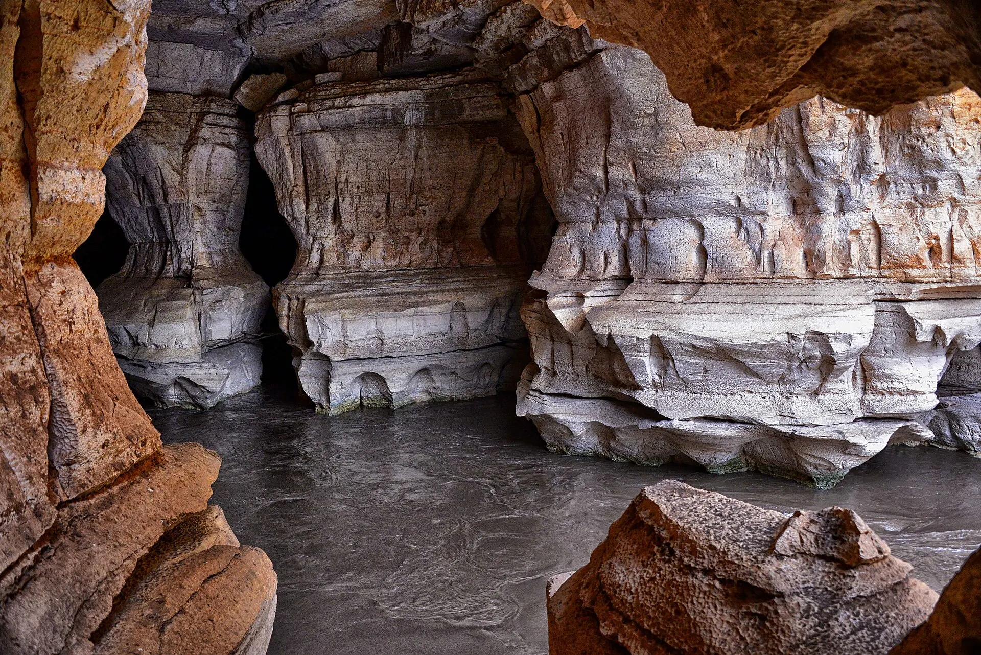 The Web River flowing through carved limestone passages in the Sof Omar caves